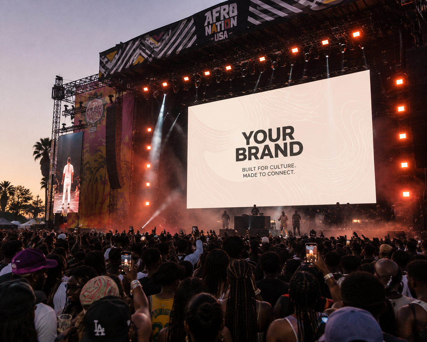 A massive festival crowd in front of a main stage screen reading 'Your Brand — built for culture, made to connect'